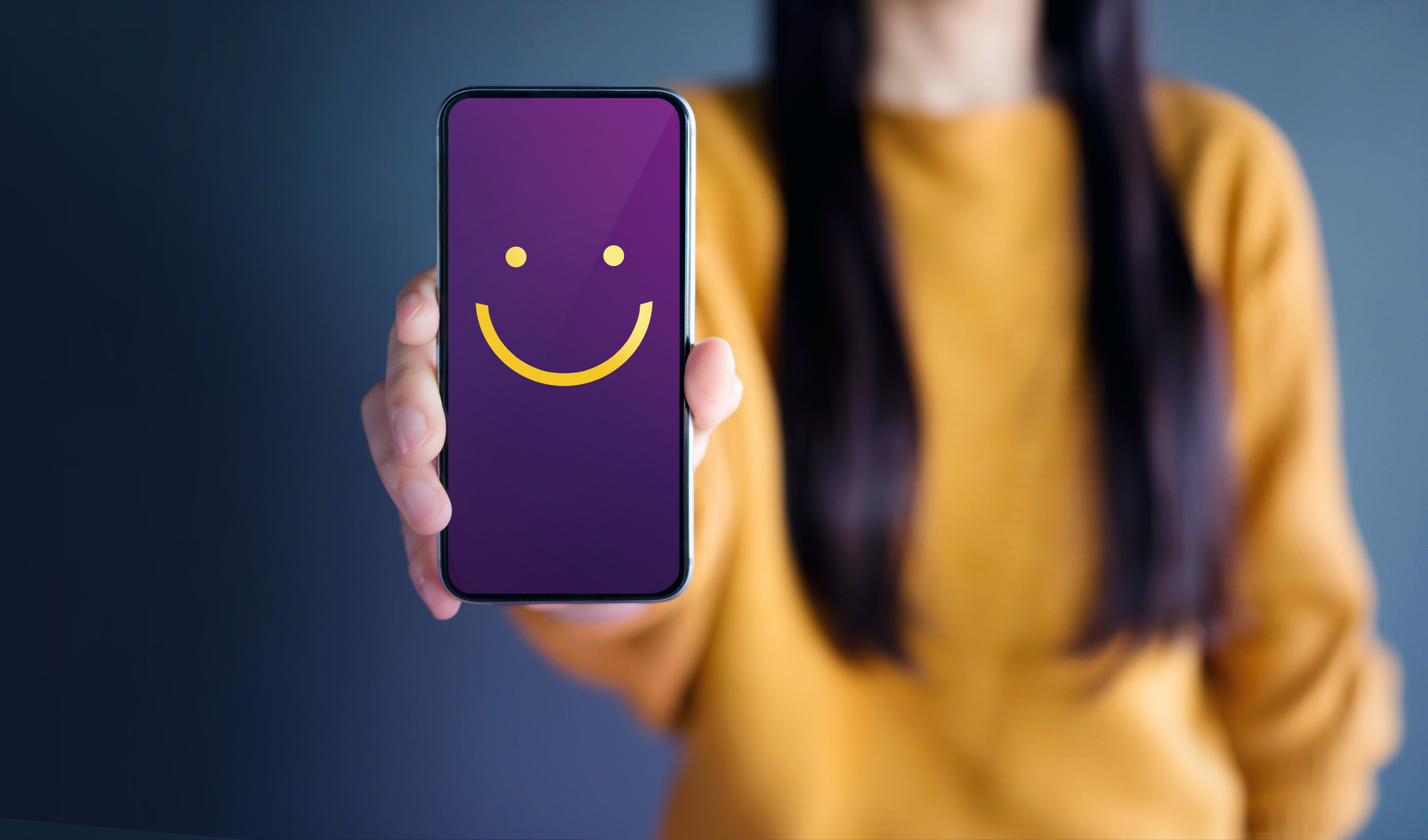 Customer Experience Concept, Happy Woman Show Smiley Face for her Satisfaction on Smart Phone