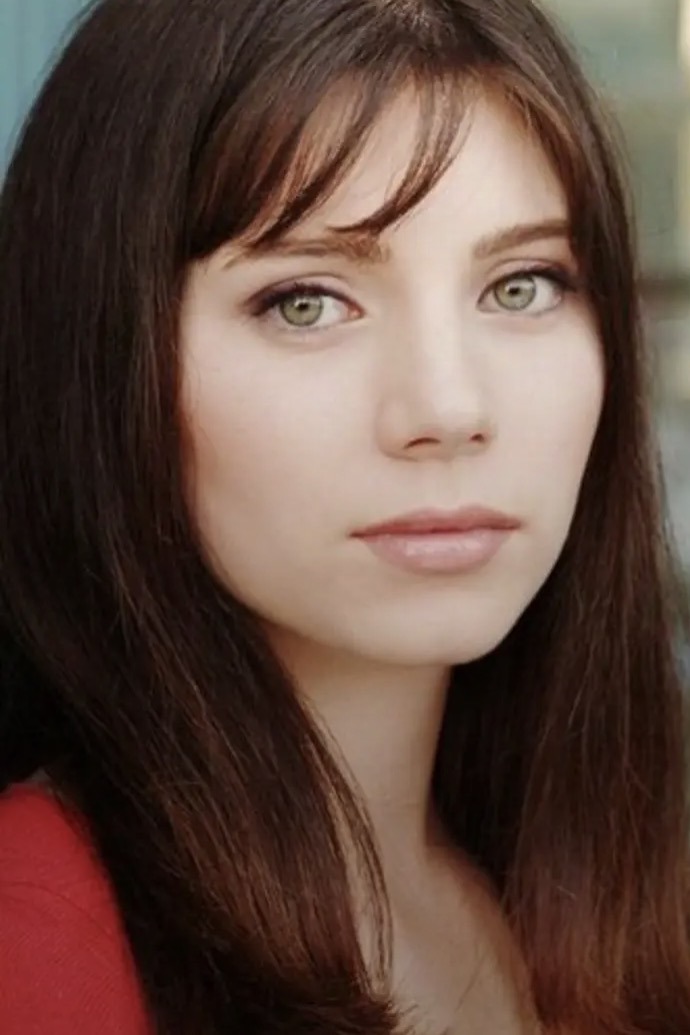Rae-Ann's first professional headshot, wearing a red top